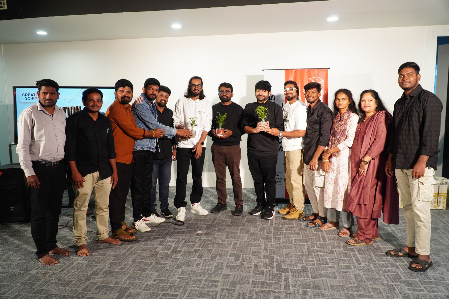 A Creator's School batch on graduation day, standing together with the awards they were given