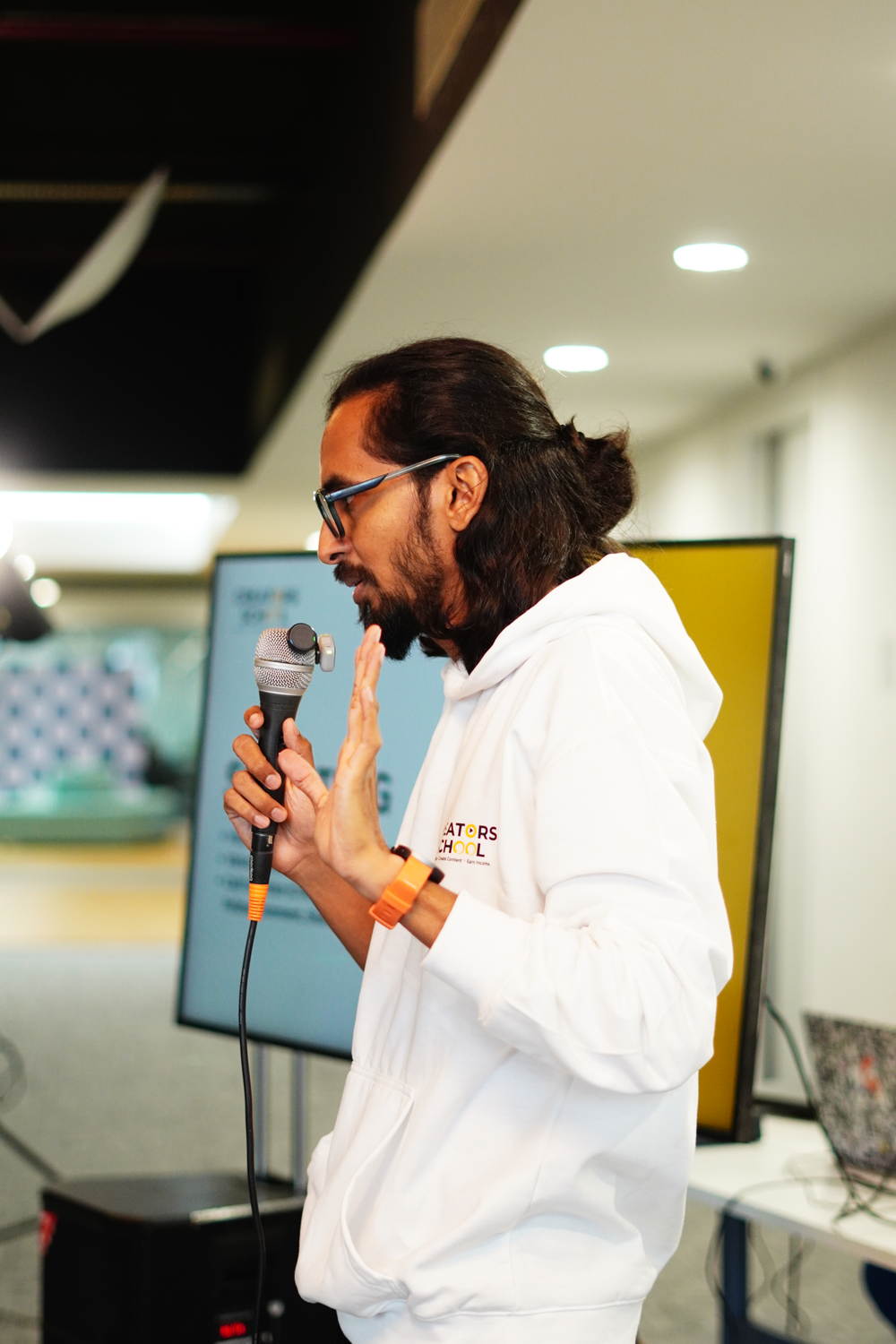 A mentor with the microphone, mid sentence