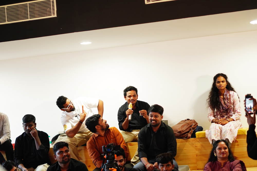 The room laughing together, cameras running